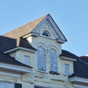 Close-up of third-story windows and roof of multistory house