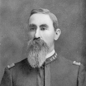 White man with long mustache and beard in military uniform