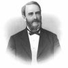 White man with beard and sideburns in suit and bow tie