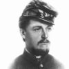 White man with thin mustache and beard in military uniform with cap