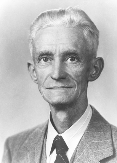 Old white man with gray hair in suit and tie
