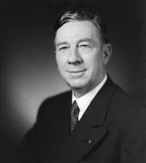 White man in suit and spotted tie