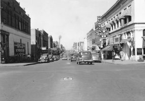 City street with traffic and "Purvis Jewelers" on the right
