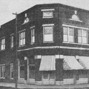 Corner building with awnings and square windows
