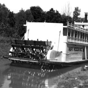 Riverboat painted "Mary Woods No. 2" tied up in shallow river