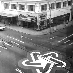 Street intersection by "Baker's Shoes" store with large star logo  and years "1776-1976" painted on road