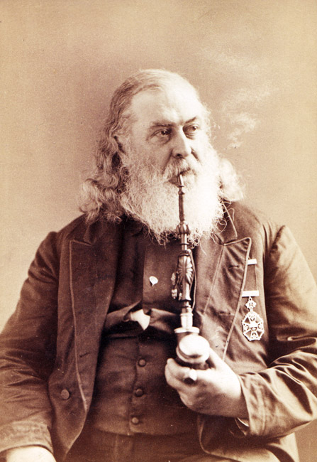 Portrait white man in suit military medal long wavy hair thick beard smoking large pipe