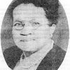 Oval portrait African-American woman wearing glasses, a pearl necklace, and dress
