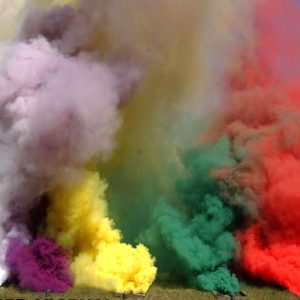 field test site with five boxes emitting large plumes of various color smoke