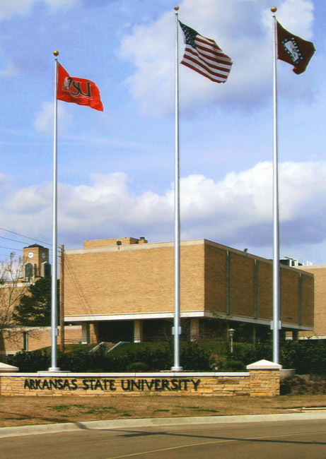 school flag, U.S. flag, and state flag outside of university