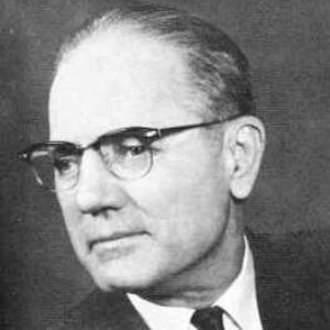 white man with glasses in suit