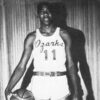 Tall African-American man in "Ozarks 11" basketball uniform with ball