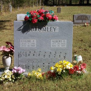 Goldie E and Albert E Brumley grave marker with flowers