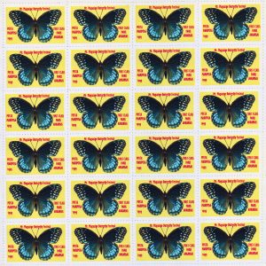 Book of stamps with blue butterfly and red text on yellow backgrounds