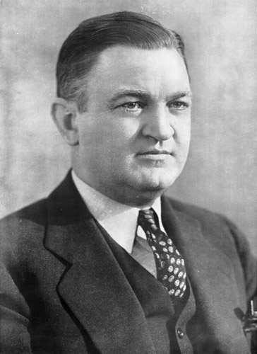 white man in suit and tie