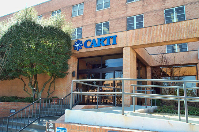 Entrance to multistory brick building with C.A.R.T.I. logo above the doors
