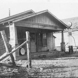 Gas station with single pump and storefront on dirt road