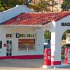 Single-story "Magnolia" gas station with covered entrance and three pumps