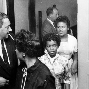 African American man and three African American women  leaving room labeled "auxiliary court room"