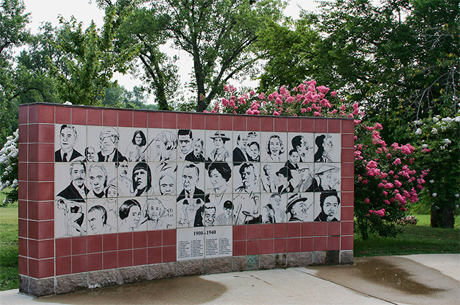 hand-drawn faces on black and white tiles on memorial wall