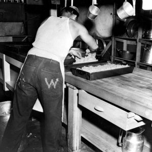 rear view of man handling ground beef with "W" stamped on his back pocket