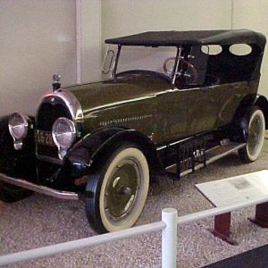 Green car on display at a museum