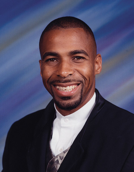 African-American man with mustache and beard in suit