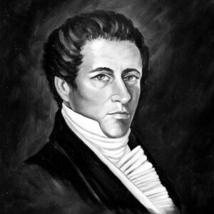 Young white man in suit and scarf with dark background