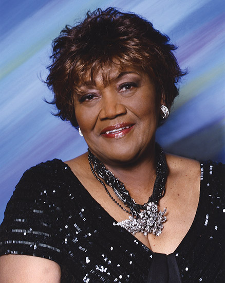 Older African-American woman smiling in necklace and dress