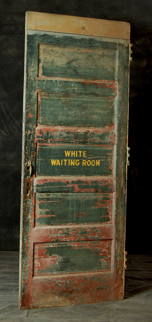 old green door with yellow lettering "White Waiting Room"