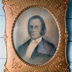 Gold-framed portrait of white man with long hair in suit