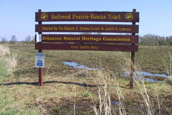 "Railroad Prairie-Downs Tract" four-tiered wooden sign in field
