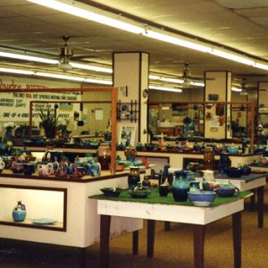 Interior of showroom with pottery for sale on tables and shelves