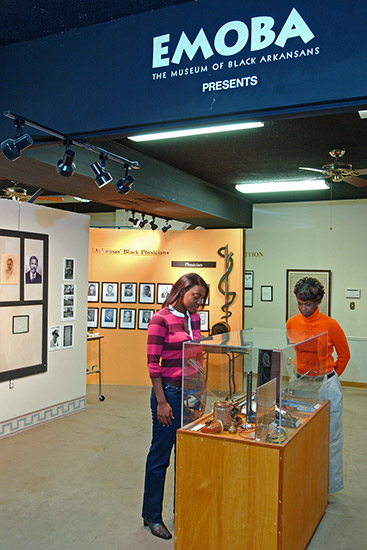 Museum interior with displays and two African-American women