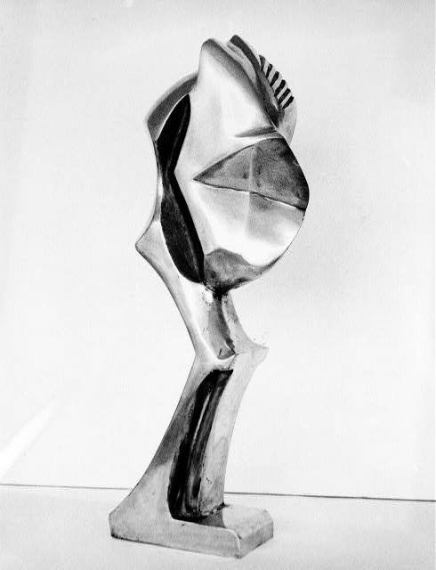 Freestanding cast bronze sculpture abstractly resembling a bent legged body with carved features