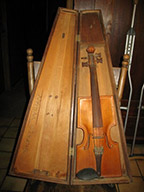 Violin with square shaped shoulders and chin rest in wooden case
