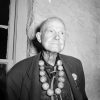 white man in large beaded necklace
