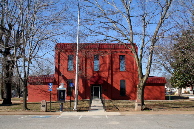 red two story building with payphone in front