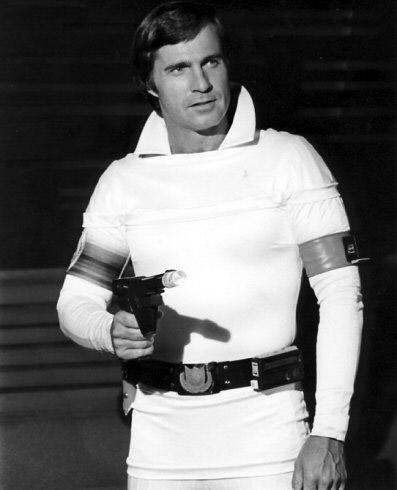 Portrait white male actor in space costume with ray gun utility belt arm bands