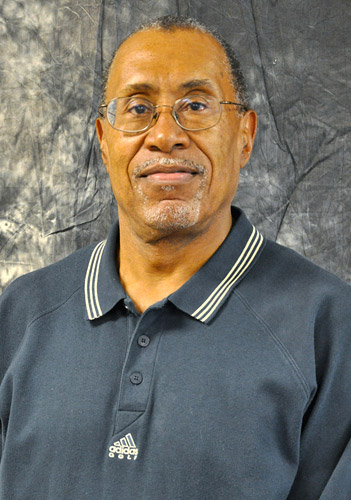 African-American man with glasses and mustache in gray collared shirt