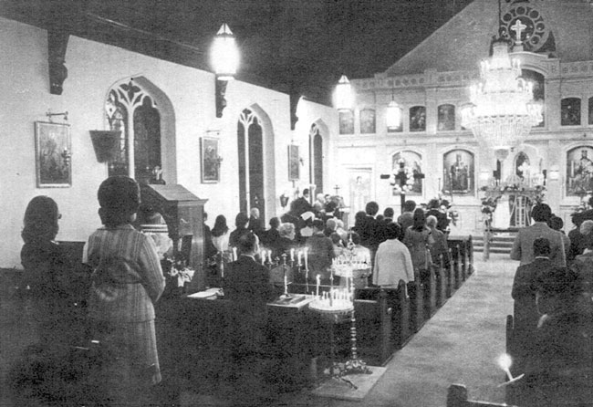 Crowd of people praying in church