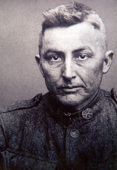 White man with close-cropped hair in military uniform