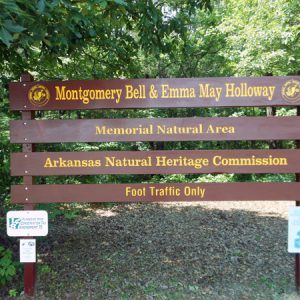 "Montgomery Bell & Emma May Holloway Memorial Natural Area" sign in forest