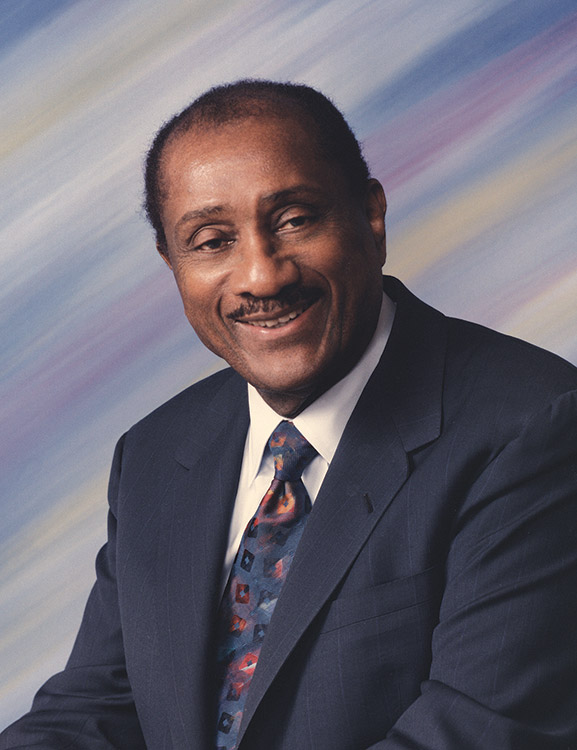 African-American man smiling in suit and tie