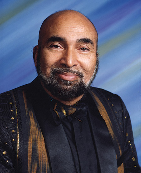 African-American man smiling with beard and suit