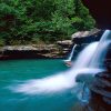 Natural rock waterfall and blueish green pool below it