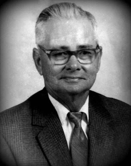 White man with glasses in suit and tie