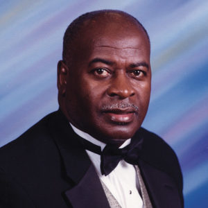 African-American man with mustache in tuxedo