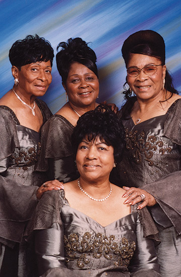 Four African-American women in matching dresses