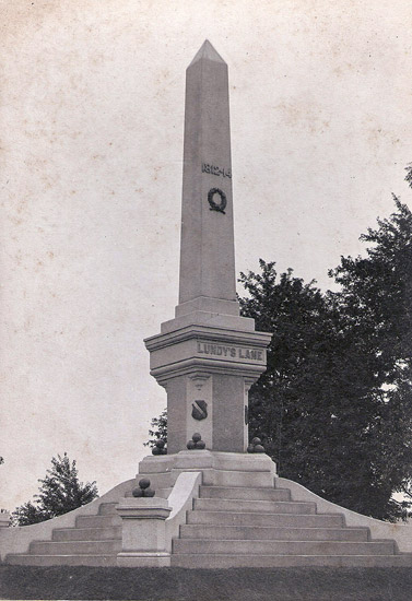Obelisk shaped monument on stepped pedestal